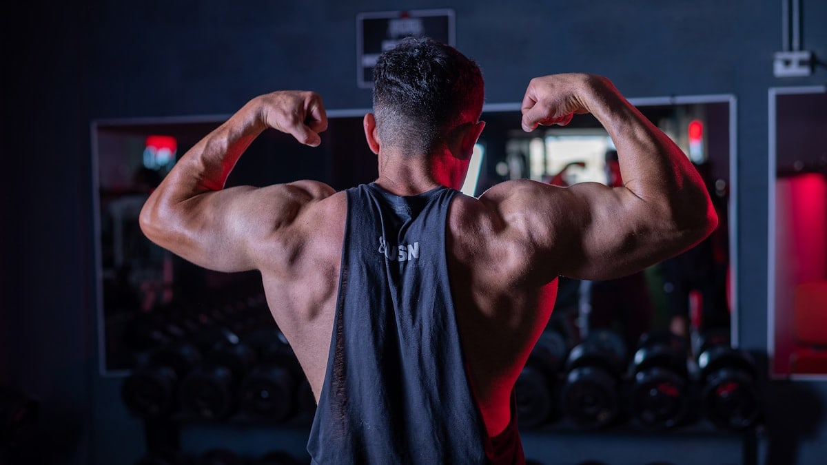 A man flexing his muscles in a gym